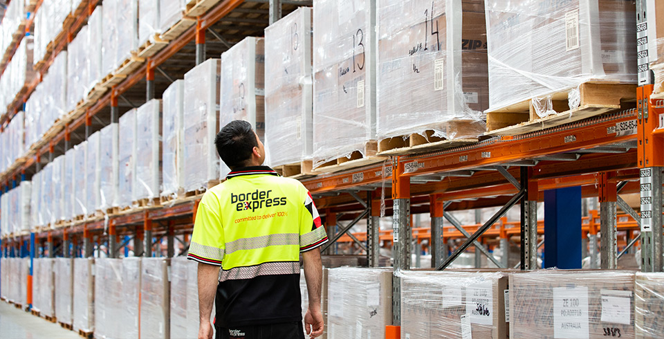border express staff examining pallets