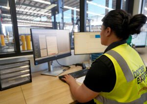 A Border Express cargo agent working at a computer A Border Express cargo agent working at a computer